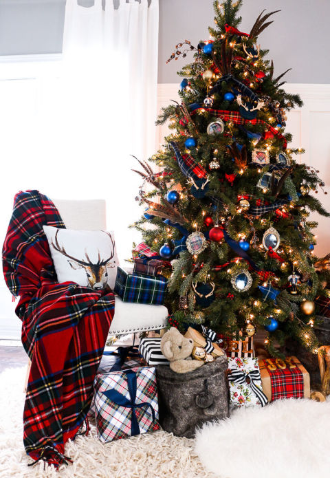Patterns of plaid and tartan cover this tree and are complemented by bright red and blue ornaments. <br>Get the tutorial at Craftberry Bush.