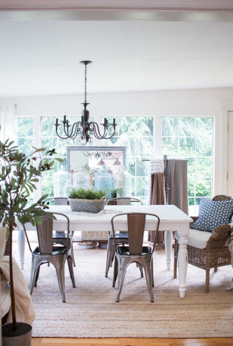 A weathered thrift shop centerpiece can be left out even after dinner guests have said goodbye. To give your space an easy, breezy vibe, mix and match metal chairs with wicker furniture.<br />See more at Zevy Joy.<br />