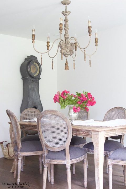 While this dining set and lighting fixture may have looked more formal with a darker wood stain, their shabby chic finish keeps the room casual.<br />See more at So Much Better With Age.<br />
