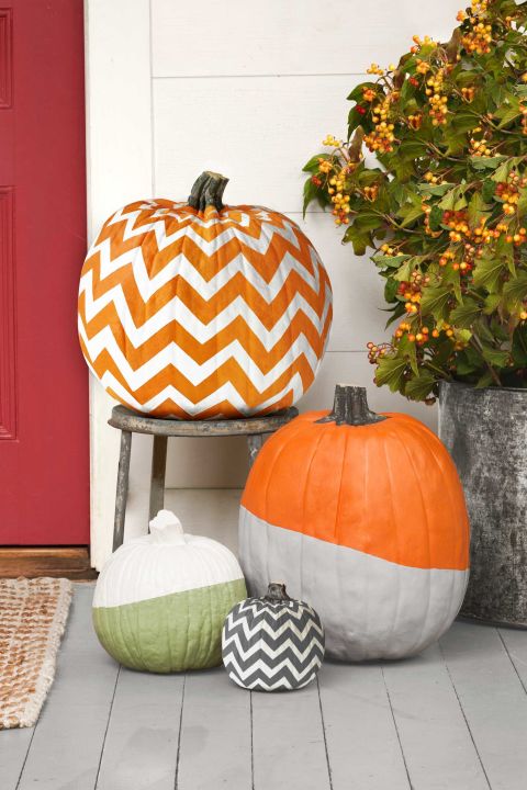 You can create all of these nifty designs using acrylic paint and painter's tape. 
For a two-tone, dipped look, bisect a pumpkin with a strip of tape (angle the tape for a diagonal effect). Use a foam brush to cover one section of your pumpkin with two coats of acrylic paint, allowing 30 minutes of drying time per coat. Remove the tape and discard. Stop there, or repeat the steps to add another color to your pumpkin. 
To form chevron stripesâ€”whether two or tonsâ€”link short strips of tape to make the zigzag patterns, using our photo as a guide. Use a foam brush to cover your pumpkin with two coats of acrylic paint, allowing 30 minutes of drying time per coat. Remove the tape and discard. Clean up the edges with a cotton swab if necessary. If you'd like the second color to be different than natural pumpkin orange, fill in using a small paintbrush and contrasting acrylic paint, as we did for the black-and-white pumpkin.
