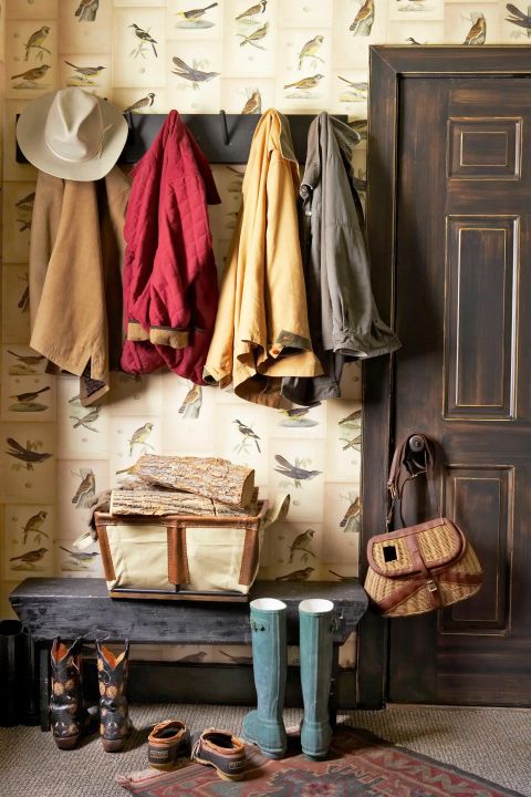 The owner of this Adirondack-style home lined her mudroom using color copies of seven antique bird prints bought for $7 each, making boots and brightly colored jackets pop against the wall.
