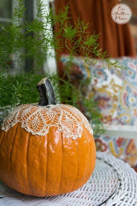 Not all pumpkins need to be carved into a spooky scene. By adding a lace doily over the stem, the pumpkin becomes a bright focal point on your front porch.&nbsp;
Get the tutorial at On Sutton Place.&nbsp;
