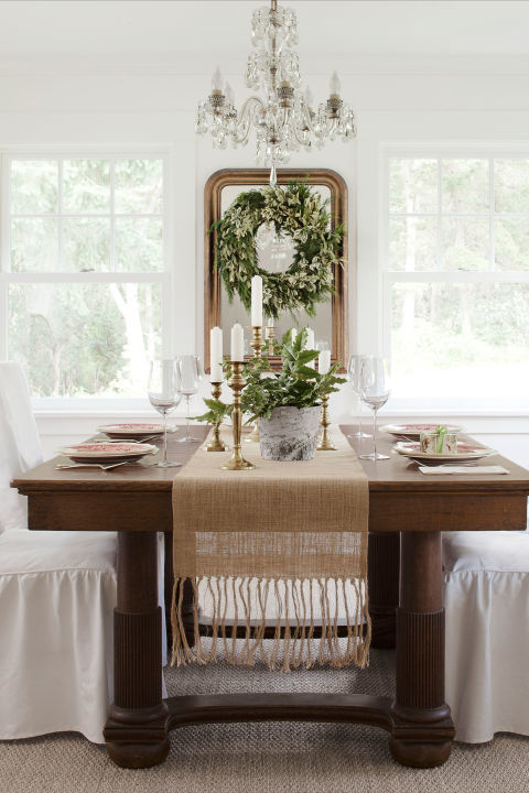 A Pottery Barn runner and Target slipcovers lighten up the heavy oak dining-room set that once belonged to Trina's great-great grandparents.
Bright idea: Turn a wreath into a framed work of art by hanging it atop a mirror.