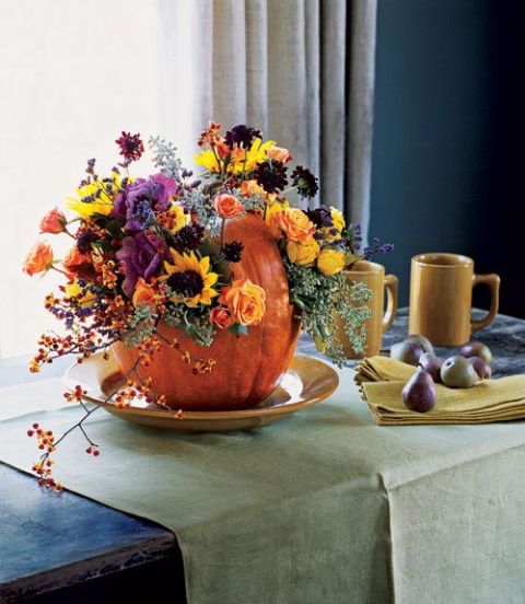 Extend a colorful welcome with this pumpkin basket floral arrangement Its as easy to make as a Jack-o-Lantern and the pumpkins rich color is a natural foil for a bunch of seasonal market flowers or the last gleanings from your gardenGet the tutorial Pumpkin Basket Floral Arrangement