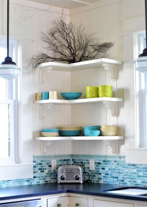 Floating shelves are super adaptable and can fit anywhere — even in an inconvenient corner between two windows. Placing bulky cabinets in this space would have eaten up the storage potential – and now the prettiest bowls and plates add to the room's decor.
See more at Centsational Girl »
