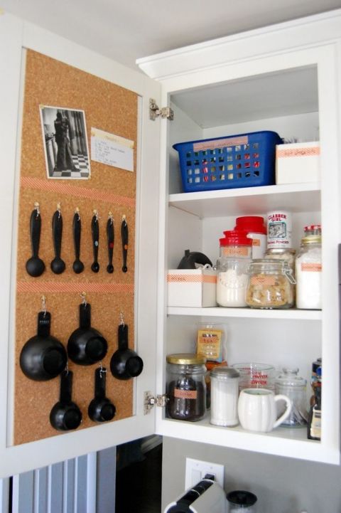 Use a cork board and pins to keep all your baking supplies in order. Flour and sugar sit inside, while measuring utensils hang from string on the opposite door and make baking a breeze. 
See more at My So Called Life »
