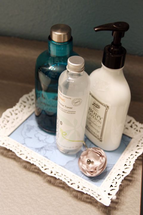 A bottle of white spray paint quickly brings life back to an old picture frame. Add a pop of color under the glass with some scrapbook paper, and you've got yourself a new vanity tray for your makeup and beauty products. 
Get the tutorial at I Heart Organizing. 
