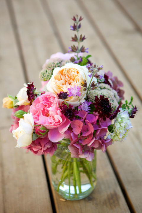 Switch off between placing bold peonies and smaller flower varieties in a clear vase for an arrangement that is loaded with texture. 