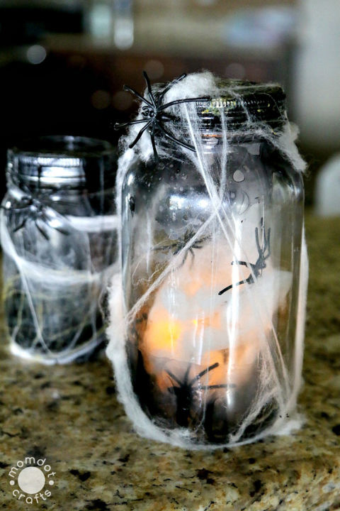 Spook your trick-or-treaters with this creepy, crawly craft.&nbsp; Get the tutorial at MomDot. What you'll need:&nbsp;Mason jars ($13 for 12; amazon.com), plastic spiders ($7 for 72; amazon.com), fake webs ($5 for 12; amazon.com), black nail polish ($10; amazon.com), tea lights ($10 for 24; amazon.com)