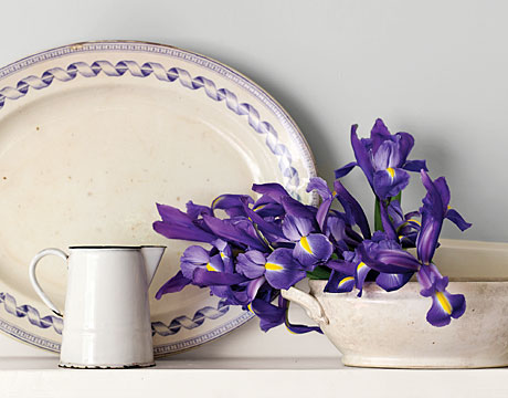 Irises, laid gently on their side in an ironstone tureen, become an insouciant display. Any favorite orphaned vessel--you might also try a compote dish or a favorite porcelain teacup on a stack of like-sized saucers--can be put to enchanting use holding flowers cut from the garden. For the most memorable effect, choose blossoms that pick up the colors in your china. 